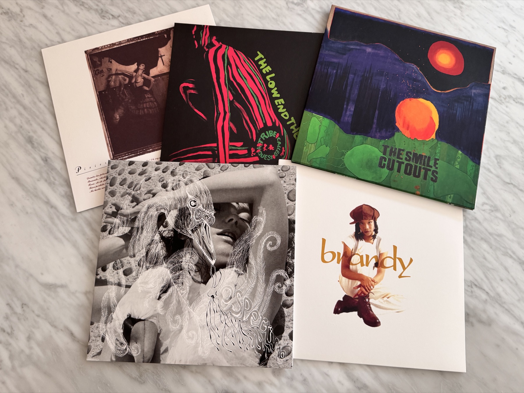 5 vinyl records on marble table